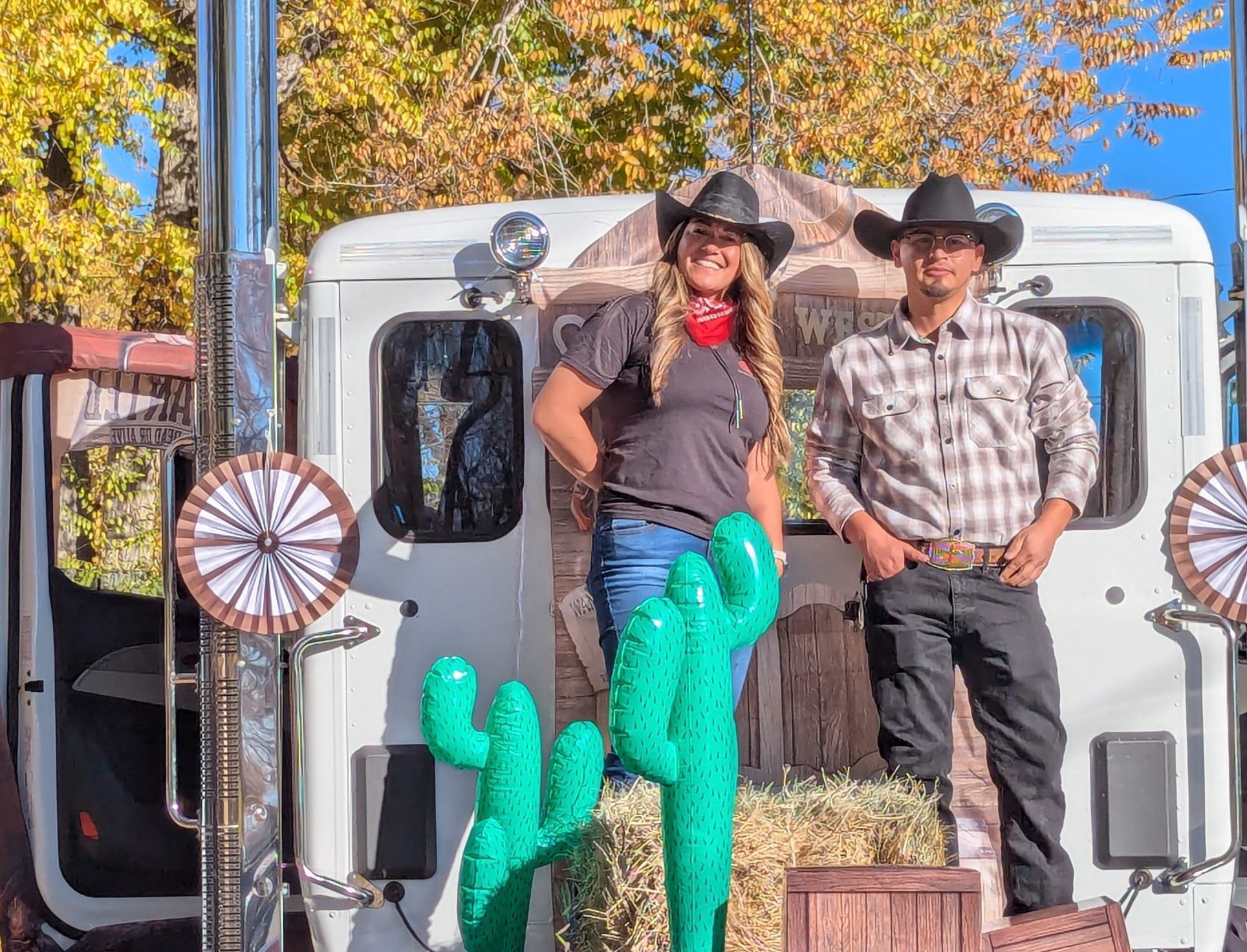Two Peterbilt employees standing on the back of a Peterbilt truck